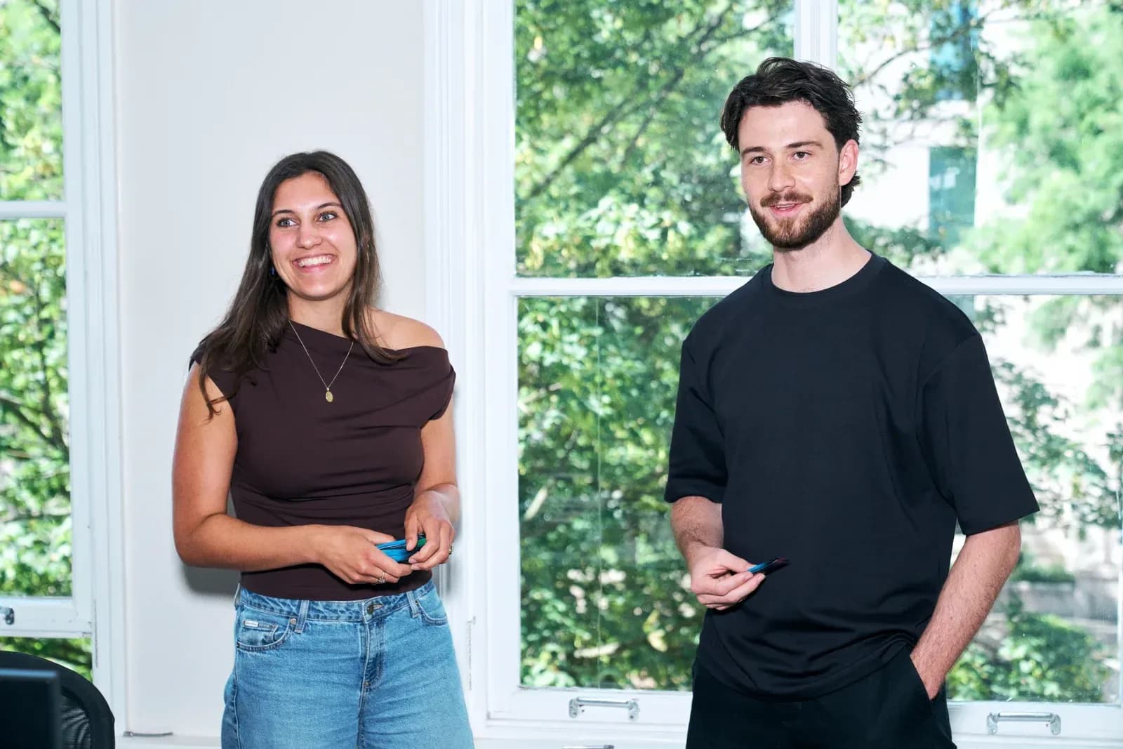 Two Whisk team members talking at the office